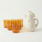 Six amber glass tumblers with rooster pitcher
