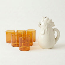 Six amber glass tumblers with rooster pitcher