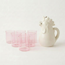 Six pink glass tumblers with rooster pitcher